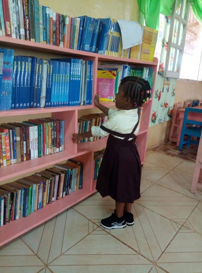 Nursery Student finds book of interest